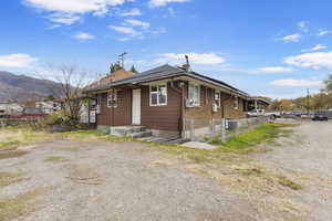 View of property exterior featuring a gate and brick siding
