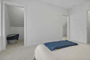 Bedroom featuring light carpet and baseboards