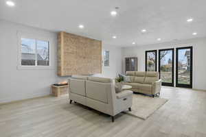 Living room with light wood-style floors and recessed lighting
