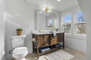Bathroom with double vanity and light wood-style floors