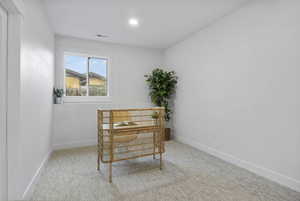 Sitting room featuring light carpet and baseboards