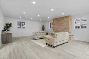 Living area featuring light wood-type flooring and recessed lighting