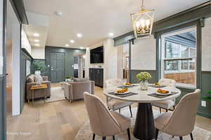 Dining space with light wood-style floors, a chandelier, and recessed lighting