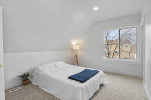 Bedroom featuring carpet, lofted ceiling, and recessed lighting