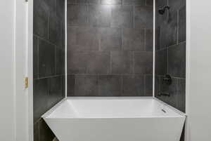 Bathroom featuring washtub / shower combination