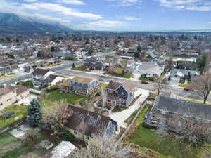 Aerial view of property and surrounding area with nearby suburban area