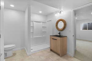 Full bathroom with vanity, a stall shower, recessed lighting, and light tile patterned floors
