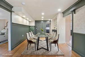 Dining area with light wood finished floors and recessed lighting