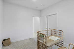 Living area with an office area and light colored carpet