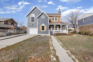 View of front of house featuring covered porch, driveway, a chimney, and an attached garage