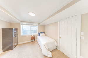 Carpeted bedroom featuring baseboards and a textured ceiling