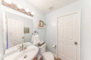 Bathroom featuring vanity and toilet