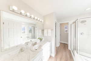 Full bathroom with a garden tub, a stall shower, vanity, light wood finished floors, and healthy amount of natural light