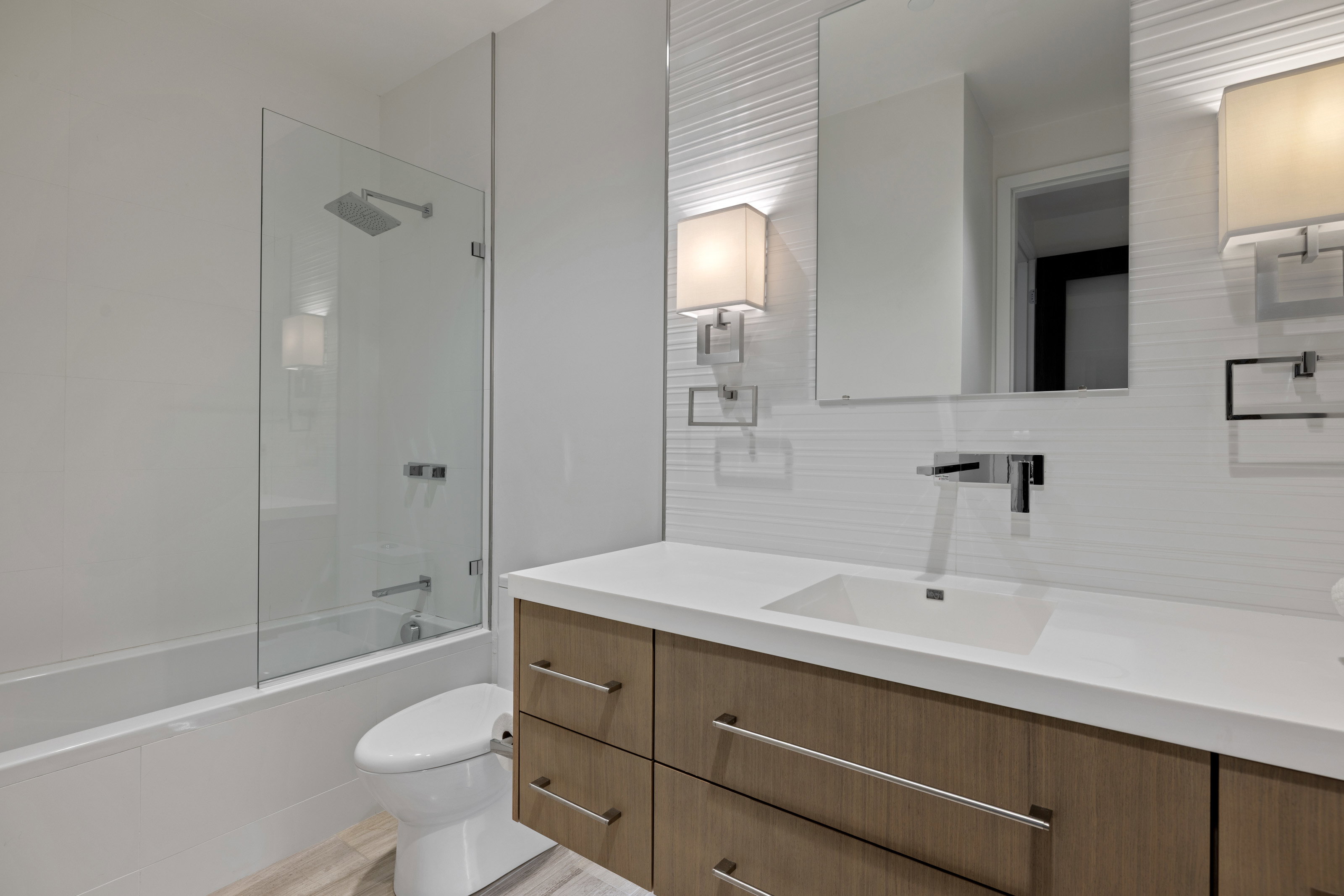 Bathroom with vanity, shower / bathtub combination, and tasteful backsplash