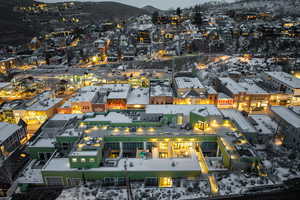 Aerial view of property and surrounding area with a mountain backdrop