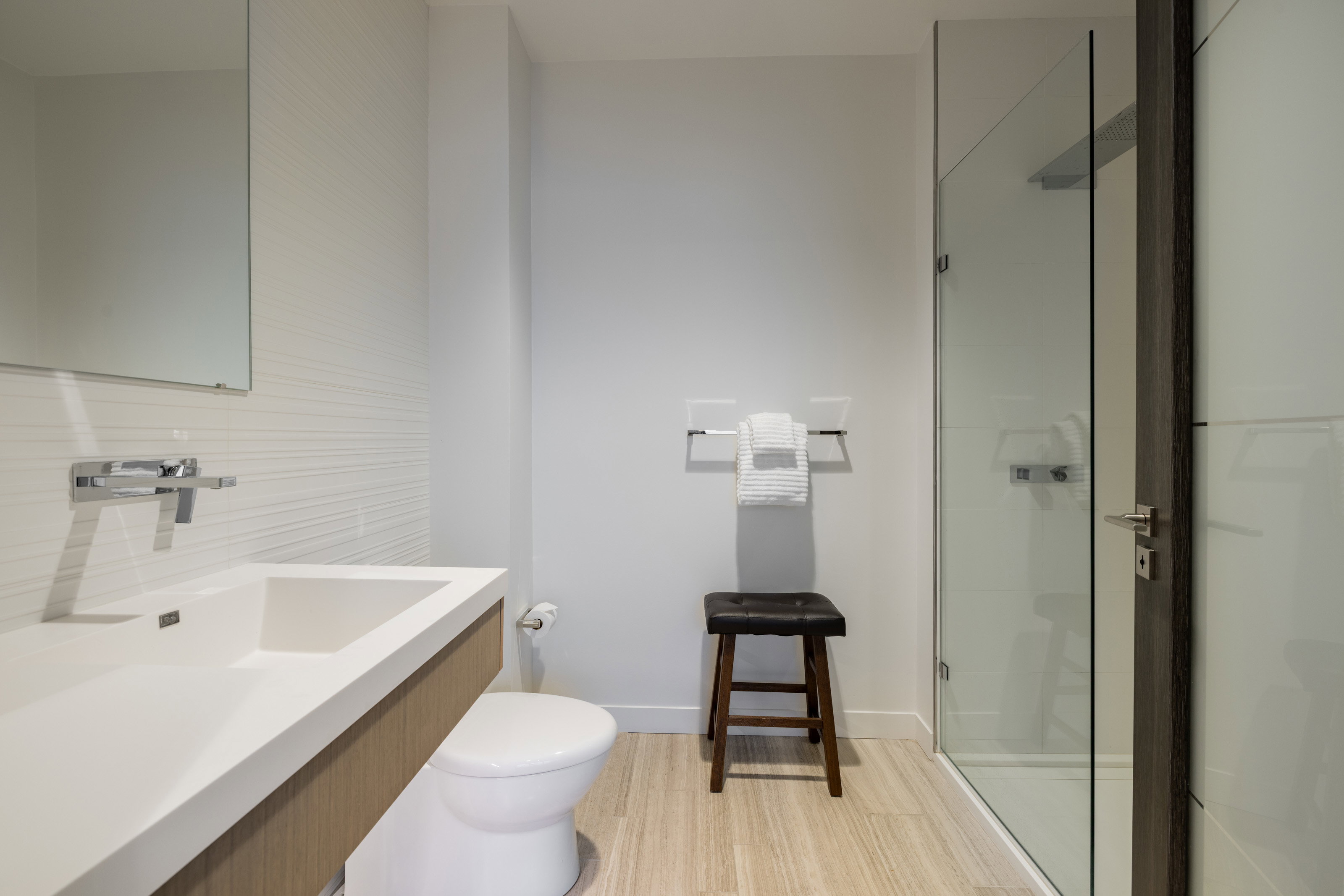 Bathroom featuring a stall shower, vanity, and light wood-style flooring