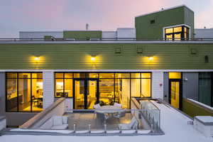 Rear view of property featuring a patio and outdoor dining space