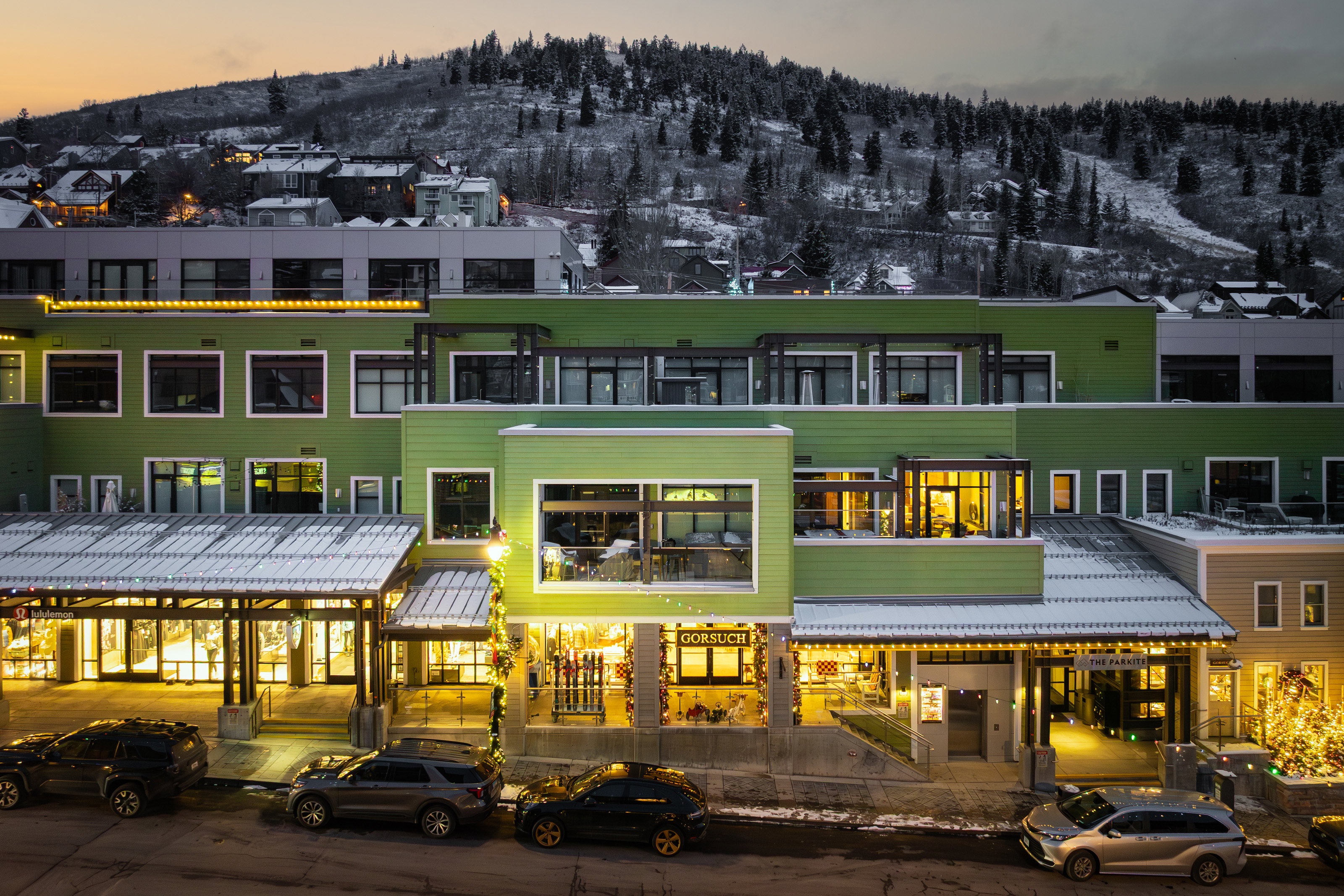 Back of property at dusk with a mountain view