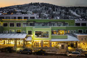 Back of property at dusk with a mountain view