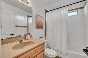 Full bath with shower / bathtub combination with curtain and vanity