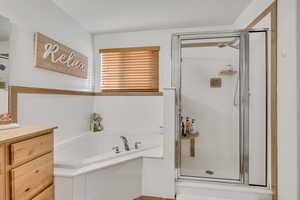 Full bath with a shower stall, a garden tub, and vanity