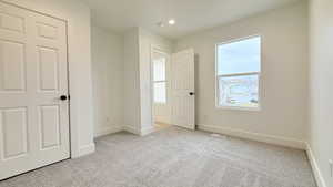 Unfurnished bedroom featuring light colored carpet and recessed lighting
