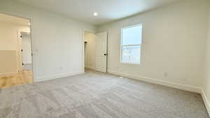 Unfurnished bedroom with carpet and recessed lighting