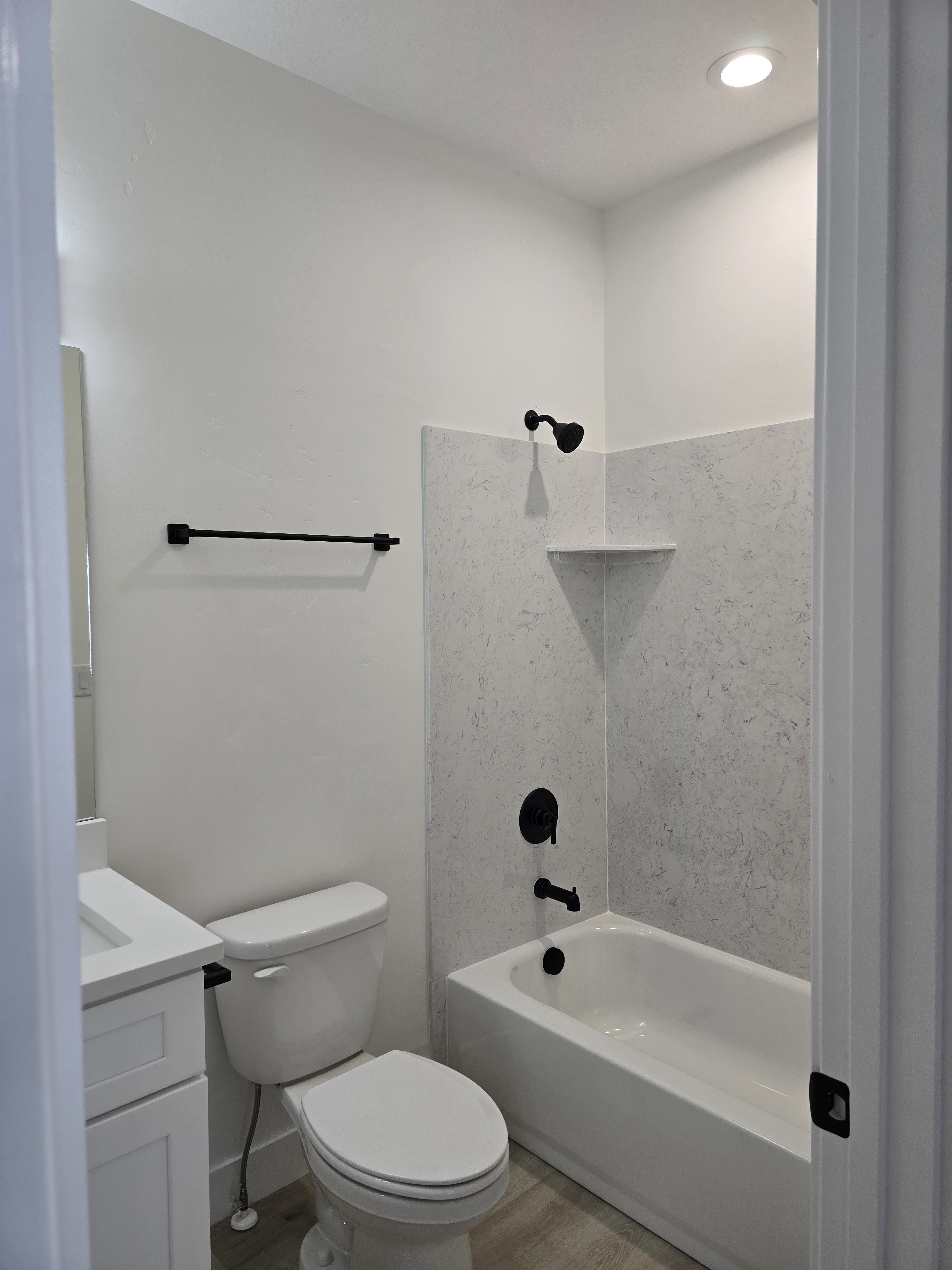 Full bathroom with vanity, washtub / shower combination, light wood-style floors, and recessed lighting
