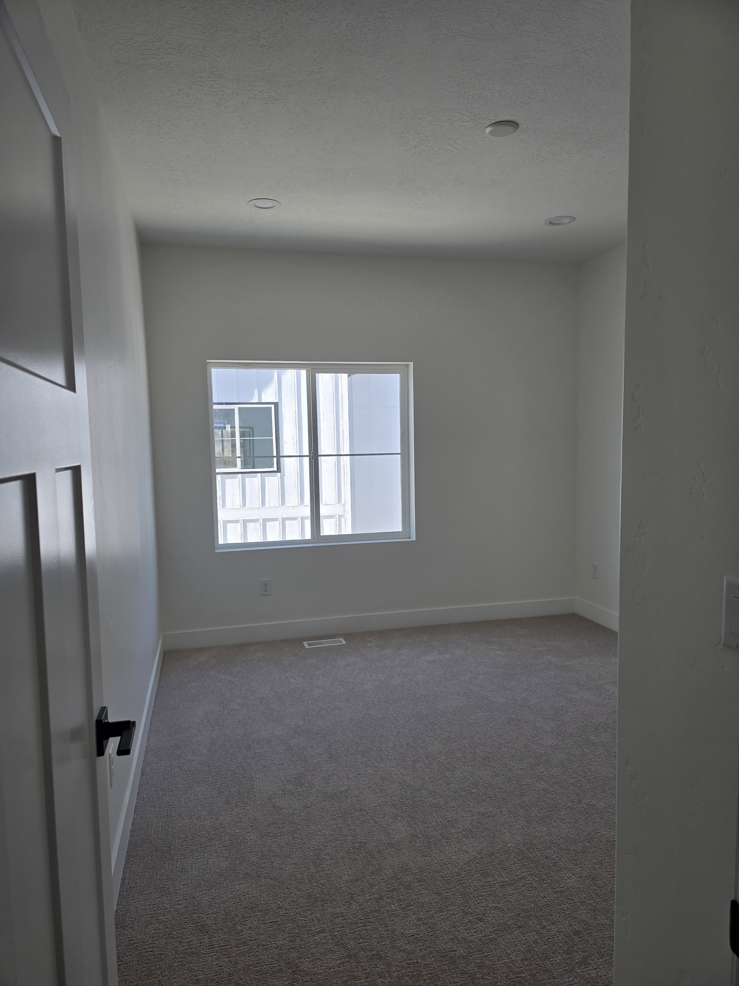 Carpeted bed room featuring baseboards and a textured ceiling