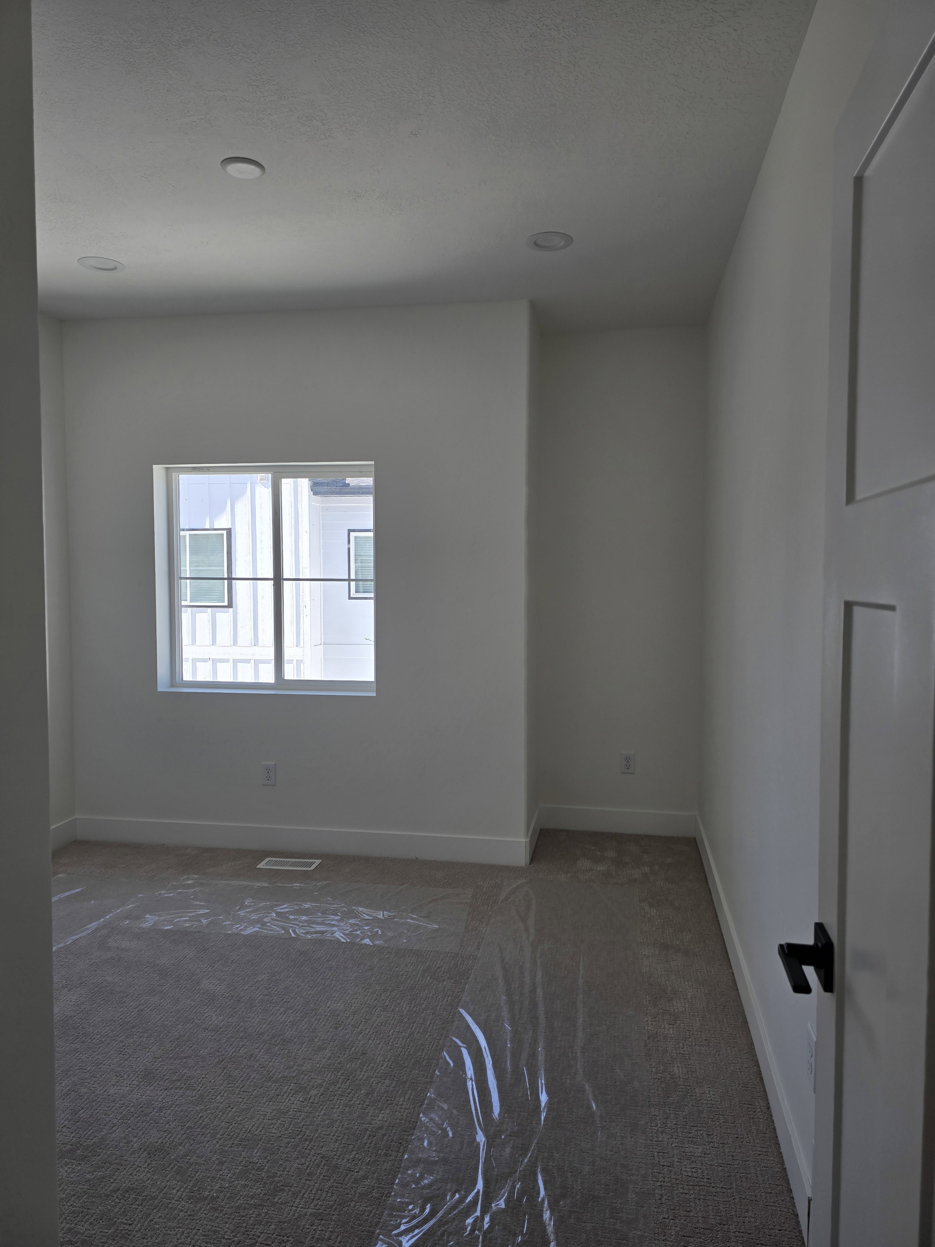 Bed room featuring dark carpet and recessed lighting