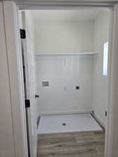 Laundry area featuring light wood finished floors, washer hookup, and hookup for an electric dryer