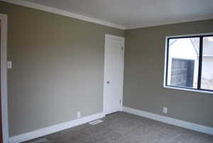 Unfurnished room with carpet floors and ornamental molding