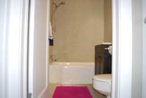 Bathroom with vanity, tub / shower combination, and tile patterned floors