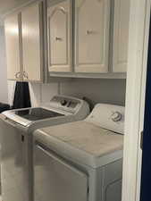 Laundry room with cabinet space and washer and dryer