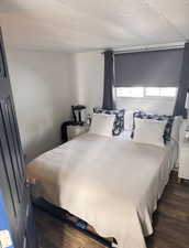 Bedroom with dark wood finished floors