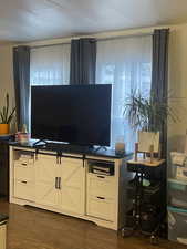 Living room with dark wood-style floors and a textured ceiling