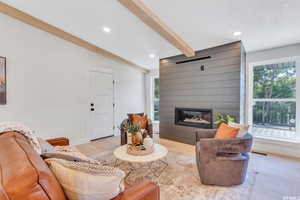 Living room featuring recessed lighting, light wood-style floors, and a fireplace