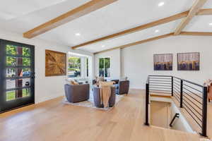 Living area with light wood-style flooring and recessed lighting