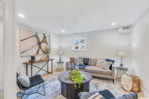 Living room with wood finished floors and recessed lighting