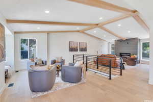 Living room with light wood-style floors and recessed lighting