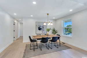 Dining area featuring light wood finished floors and recessed lighting