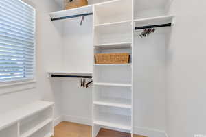 Spacious closet featuring light wood-type flooring