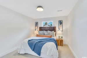 Bedroom with carpet floors and baseboards