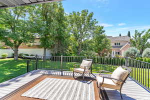 Wooden terrace featuring a yard