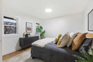 Bedroom featuring light wood-style floors and baseboards