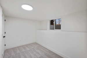 Carpeted empty room featuring baseboards