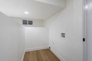 Laundry area with hardwood / wood-style floors, washer hookup, recessed lighting, and electric dryer hookup
