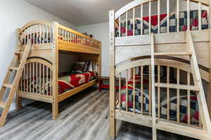 Bedroom with a textured ceiling and light wood-style flooring
