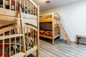 Bedroom with wood finished floors and a textured ceiling