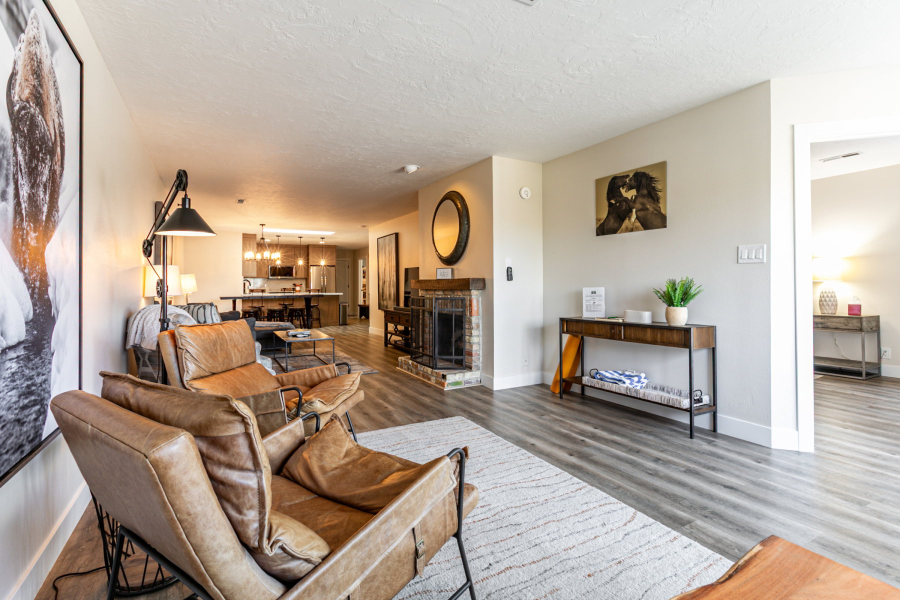 Living area featuring wood finished floors, a textured ceiling, and a chandelier